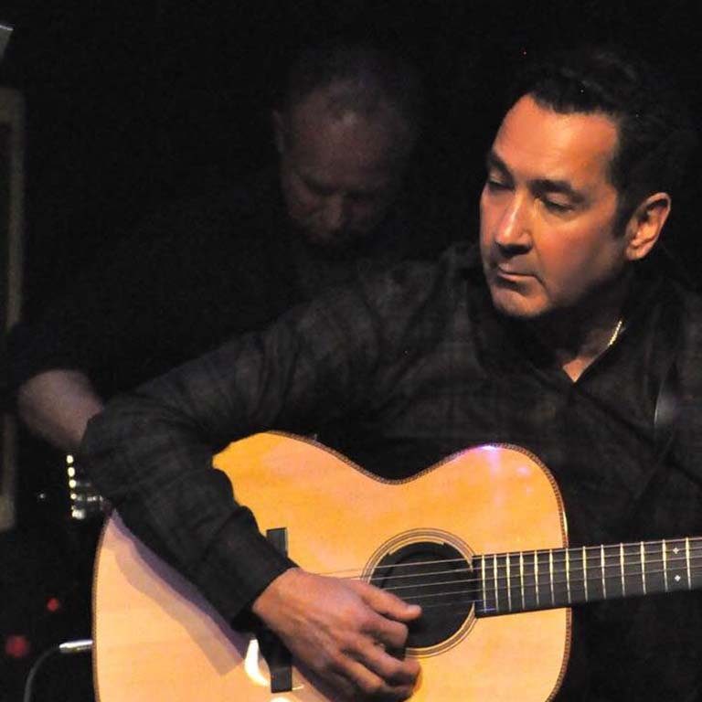 Lawrence Blatt playing an acoustic guitar, ca2020. Photo by Liz Linder, www.lizlinder.com. Courtesy of Lawrence Blatt.