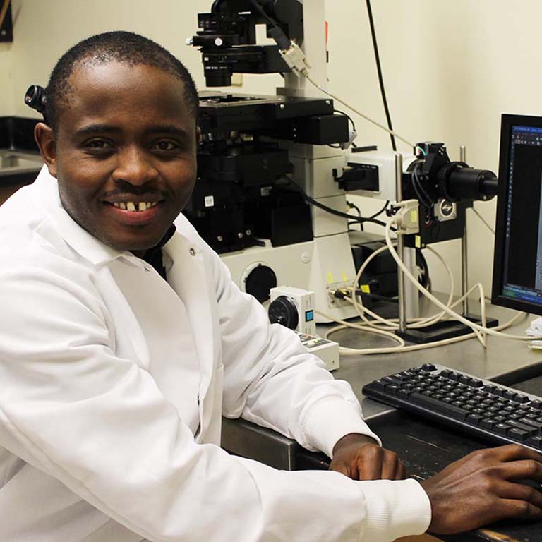 Gabriel Muhire Gihana at a computer in the lab.