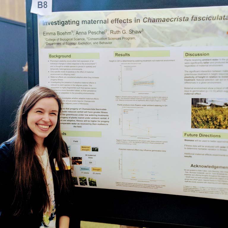 Emma Boehm presenting a poster at a conference.