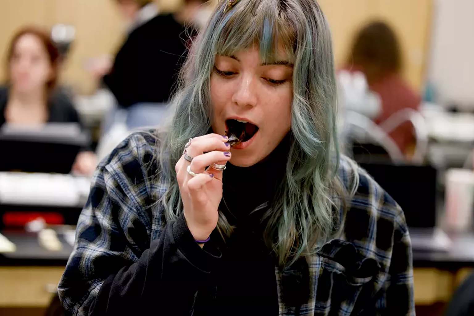 IU senior McKenna Conway eats a giant water bug during the final meeting of the lab section of BIOL-Z 373 Entomology at IU Bloomington.