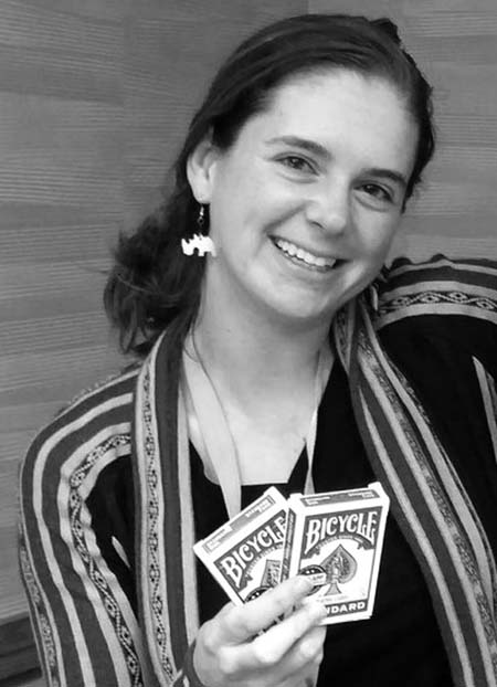 Mandy Gibson holding two decks of playing cards.