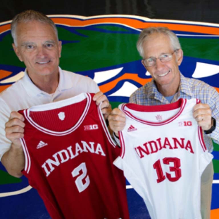 Rob Ferl (left) and Doug Soltis proudly hold up Hoosier basketball jerseys at the Stephen O’Connell Center—home of the Florida Gators—on the campus of the University of Florida, where they both work.