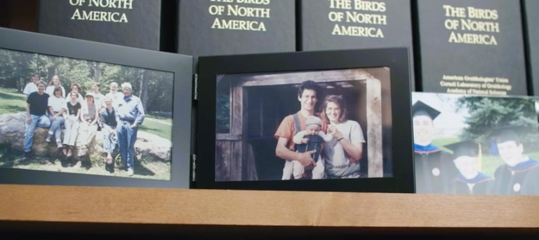 Family photos arranged on a shelf.